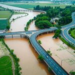 A serene landscape depicting flooded fields and highways surrounded by greenery after heavy rainfall.