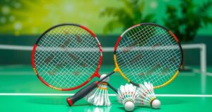 Two badminton rackets crossed with shuttlecocks on a court background representing a sports victory.