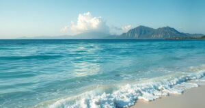 A serene landscape depicting a calm sea and distant mountains, symbolizing hope and renewal in regional unity.